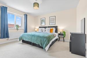 a bedroom with a bed and a window at Stylish 4 Bedroom House in St Neots w Free Parking in Saint Neots