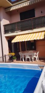 a patio with a table and chairs next to a house at Casa PO LAZISE in Lazise +37 photos