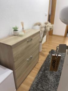 a wooden dresser in a room with a tag on it at Apartman 007 in Jajce +26 photos