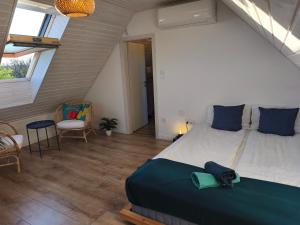 A bed or beds in a room at Napraszállás Vendégház