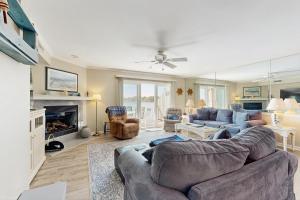 a living room with a couch and a fireplace at Salt Pond - 15 Schooner Vill in Bethany Beach
