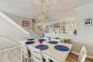 a dining room with a white table and chairs at Salt Pond - 15 Schooner Vill in Bethany Beach