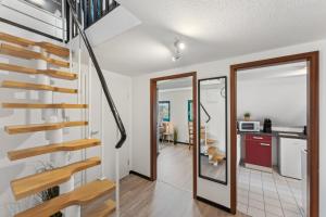 a home with a spiral staircase and a kitchen at Larooms - Naumi#1 in Merseburg