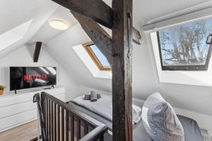 a small attic bedroom with a bed and a window at Larooms - Naumi#1 in Merseburg