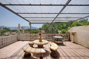 a patio with awning and tables and chairs at Villa Rita al Vesuvio in Terzigno +12 photos