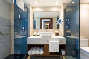 a bathroom with a sink and a mirror at Sonesta Maho Beach All Inclusive Resort Casino & Spa in Maho Reef