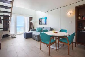 a living room with a table and chairs and a couch at Sonesta Maho Beach All Inclusive Resort Casino & Spa in Maho Reef