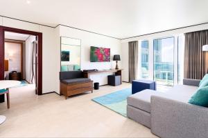 a living room with a couch and a desk at Sonesta Maho Beach All Inclusive Resort Casino & Spa in Maho Reef