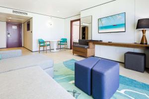 a living room with a couch and a table at Sonesta Maho Beach All Inclusive Resort Casino & Spa in Maho Reef