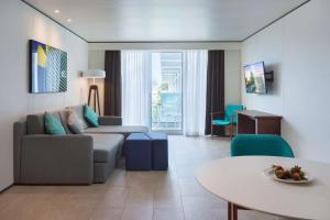 a living room with a couch and a table at Sonesta Maho Beach All Inclusive Resort Casino & Spa in Maho Reef