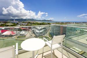 a balcony with a white table and two chairs at Sonesta Maho Beach All Inclusive Resort Casino & Spa in Maho Reef