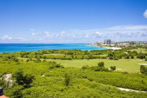 an aerial view of a golf course near the ocean at Sonesta Maho Beach All Inclusive Resort Casino & Spa in Maho Reef