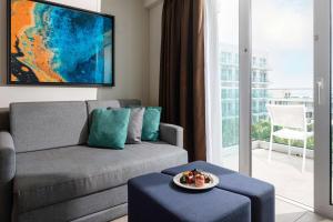 a living room with a couch and a table at Sonesta Maho Beach All Inclusive Resort Casino & Spa in Maho Reef