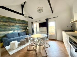 a living room with a blue couch and a table at Ker Yuna & Spa in Dinan