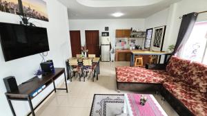 a living room with a couch and a table at Rawai Naiharn 3 bedroom house in Rawai Beach