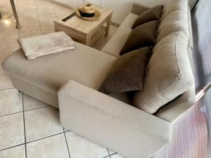 a couch with pillows on it in a living room at TomNok in Salou