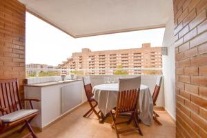 a dining room with a table and chairs on a balcony at Magic Sunset View in El Borseral