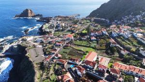 an aerial view of a village on the coast at Pôr do Sol I in Porto Moniz