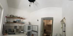 a kitchen with a white refrigerator and a mirror at Sunset House in Serifos Chora +35 photos