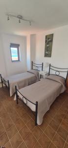 a room with two beds in a room with at Finestra sul porto in Marina di Camerota