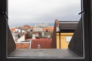 a view of a city from an open window at Pensjonat Jarlen in Trondheim