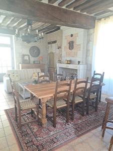 a dining room with a wooden table and chairs at Chambres d'Hôtes L'Ecu in Preuilly-sur-Claise +53 photos