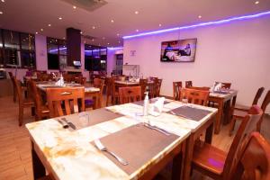 a dining room with wooden tables and chairs at West Lerruat Hotel in Nairobi