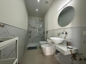 a white bathroom with a sink and a mirror at Villa Paestum in Paestum +82 photos