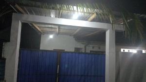 a building with a blue gate with a light on it at Una Star Guest House in Trincomalee +18 photos
