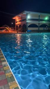 a swimming pool at night with a building at Orilla Transient 1 in Mabalacat +16 photos