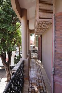 a porch of a house with a fence and a tree at Riad spa Villa Marrakech in Marrakech