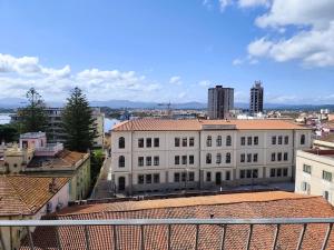 a large white building on top of a city at Marysel Rooms in Olbia +61 photos