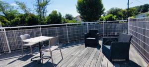 a balcony with chairs and a table and a fence at Hôtel Le Boïate in Arès