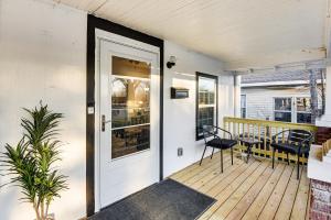a door on a deck with a table and chairs at 1 Mi to Tulsa Arts District Updated Home with Deck! in Tulsa +17 photos