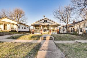 a large white house with a pathway in front of it at 1 Mi to Tulsa Arts District Updated Home with Deck! in Tulsa