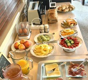 a table with many plates of food on it at Hôtel Le Boïate in Arès