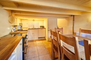 a kitchen with a table and chairs in a room at Host & Stay - Ship's Bell in Staithes +12 photos