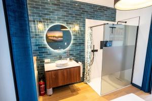 a bathroom with a sink and a shower at Huswell - Chic Studio with Garden in Central Ghent in Ghent +15 photos