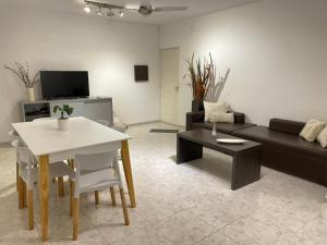 a living room with a white table and a couch at Torre Kalinka dos dormitorios pleno centro 6 personas in Villa Carlos Paz