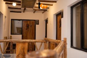 a room with a wooden door and windows at Kory Wasy Hostal - Uyuni in Uyuni