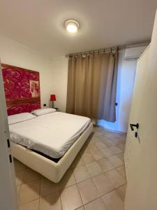 Ένα ή περισσότερα κρεβάτια σε δωμάτιο στο Appartamento Napoleon Isola D Elba