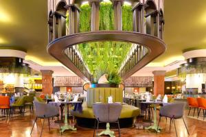a restaurant with tables and chairs and a large mirror at R2 Rio Calma in Costa Calma
