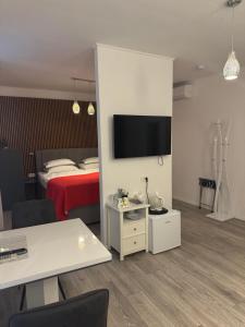 a hotel room with a bed and a tv on a wall at Palace Wall Residences in Split