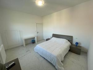 a bedroom with a large white bed in it at Attico Marsiglie in Casal Fiumanese