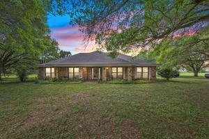 a house with a large yard in front of it at Cajun Stays Cozy 3BR Ranch Near Lafayette with WiFi and Parking in Broussard