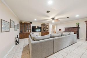 a large living room with a couch and a kitchen at Cajun Stays Cozy 3BR Ranch Near Lafayette with WiFi and Parking in Broussard