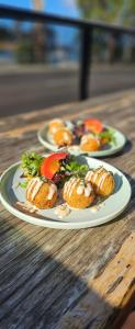 two plates of food on a wooden table at The Wharf Hotel in Wynyard