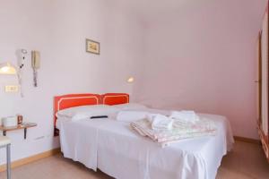 Postel nebo postele na pokoji v ubytování HOTEL Donati
