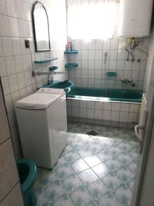 a bathroom with a tub and a toilet and a sink at Apartment Balatonfenyves - Balaton 18403 in Balatonfenyves