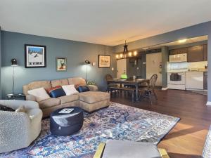 a living room with a couch and a table at Moose Tracks Lodge - Pool, Hot Tub, Golf, Sauna in Killington
